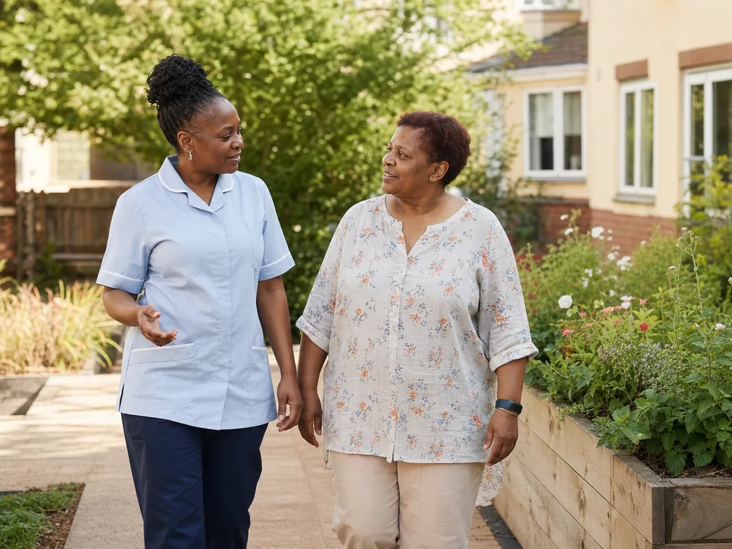 Support worker walking and talking with an adult service user in a community garden.